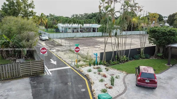 a view of a backyard with wooden fence