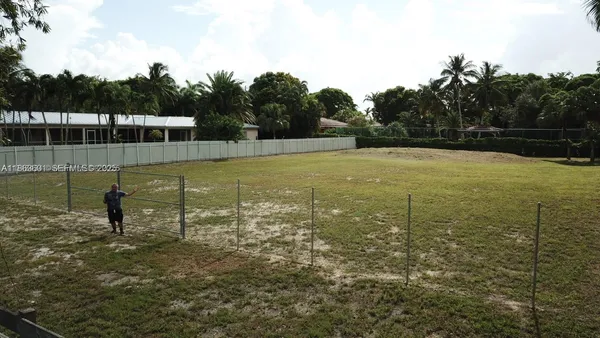 an aerial view of a house with swimming pool and porch with furniture