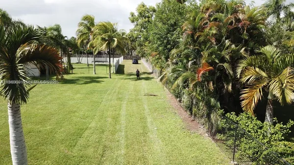 a view of a patio with table and chairs and potted plants