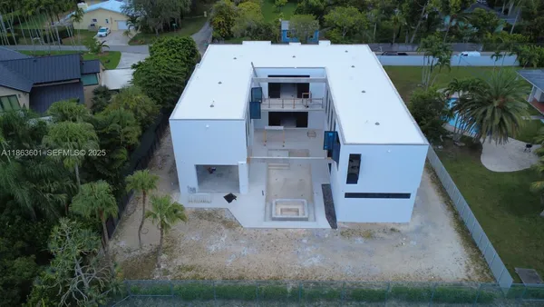 an aerial view of a house with a yard