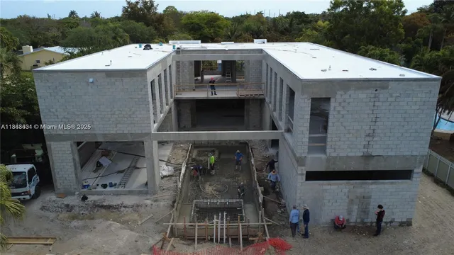 a view of a patio with a table chairs and a potted plant