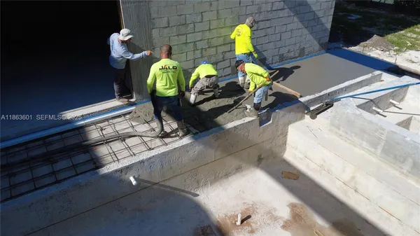 an aerial view of a house with a yard and balcony
