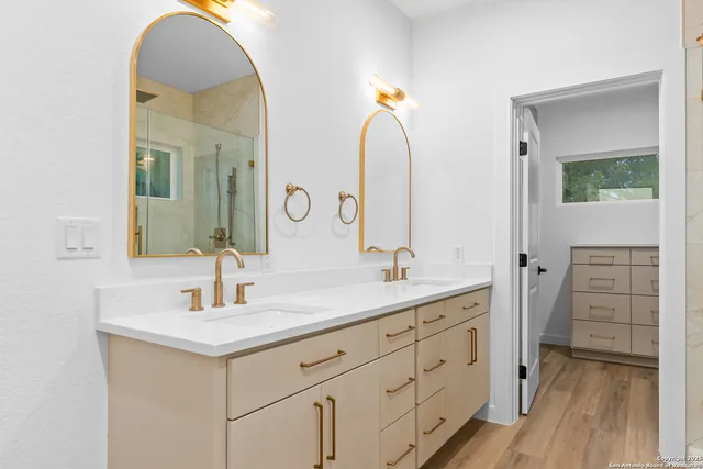 a bathroom with a double vanity sink and mirror