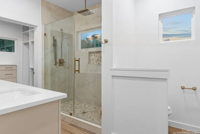 a bathroom with a shower and sink