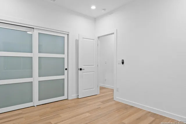 a view of an empty room with wooden floor