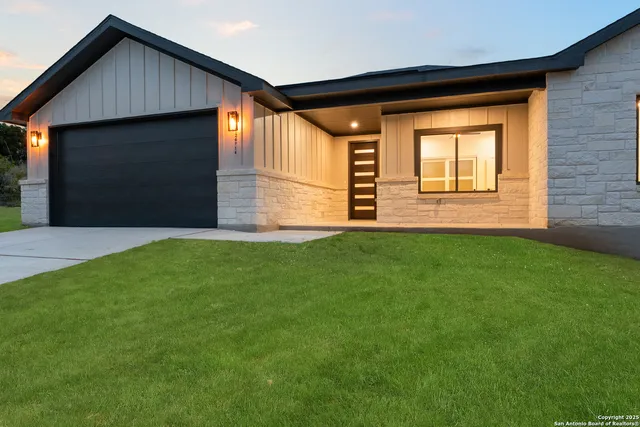 a front view of house with yard and green space