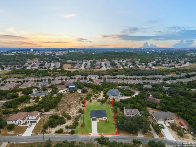 an aerial view of residential building with green space