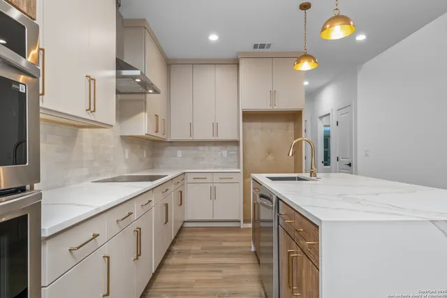 a kitchen with a sink dishwasher and cabinets
