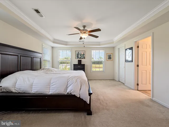 a living room with a fireplace a flat screen tv and a couch