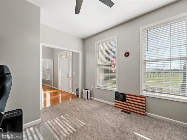 a kitchen with granite countertop a stove a sink a dining table and chairs with wooden floor