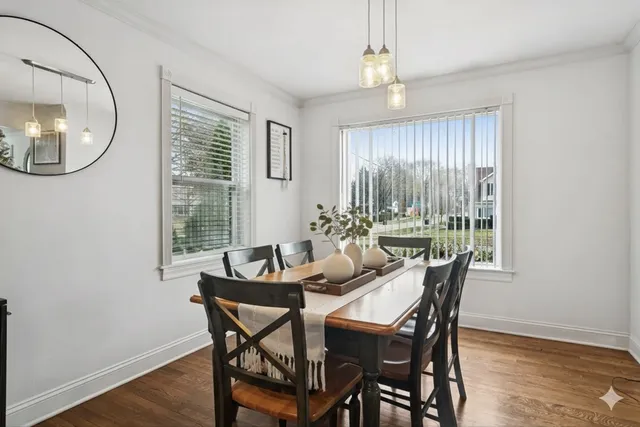 a dining room with furniture a mirror and a window