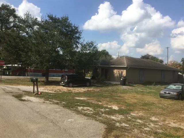 a backyard of a house with yard and barbeque oven