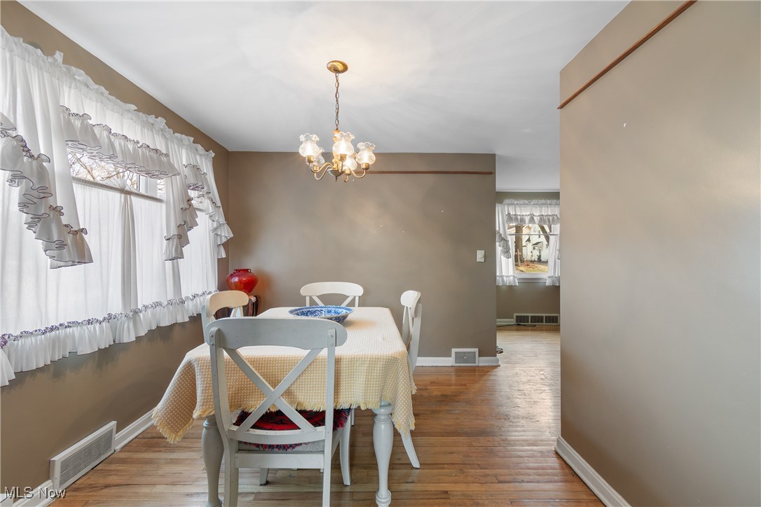 1527 Ridge Road Northwest Canton, OH 44703 - Photo 9 of 27 Dining room featuring hardwood / wood-style flooring and a notable chandelier