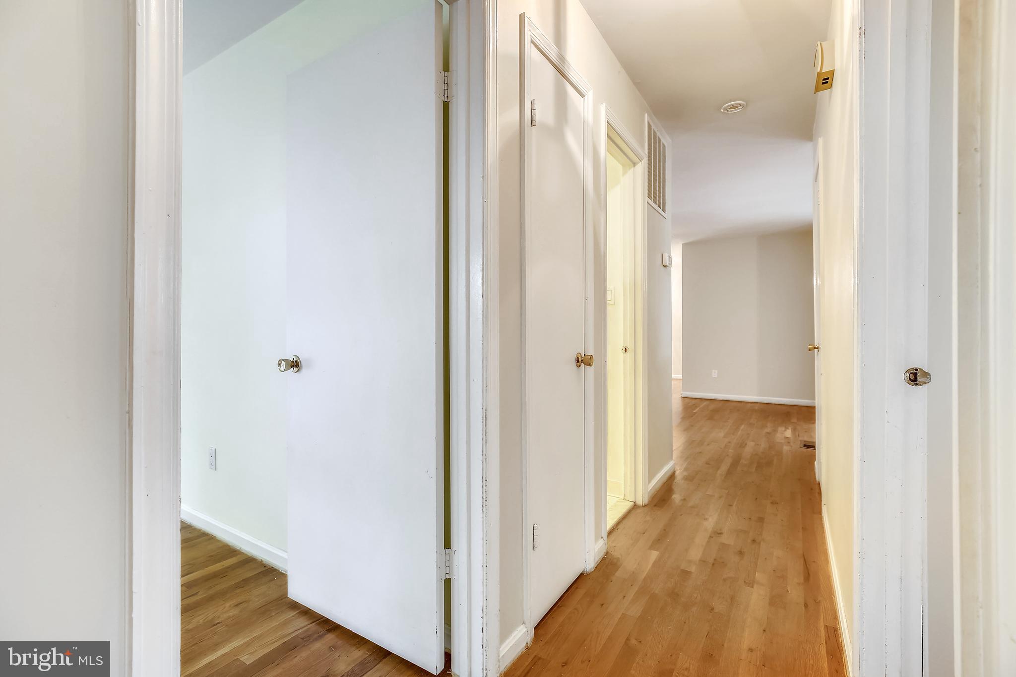 9505 Emory Grove Road Gaithersburg, MD 20877 - Photo 29 of 75 a view of a hallway with a wooden floor