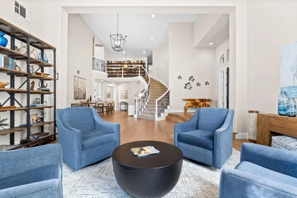 a living room with furniture and large windows