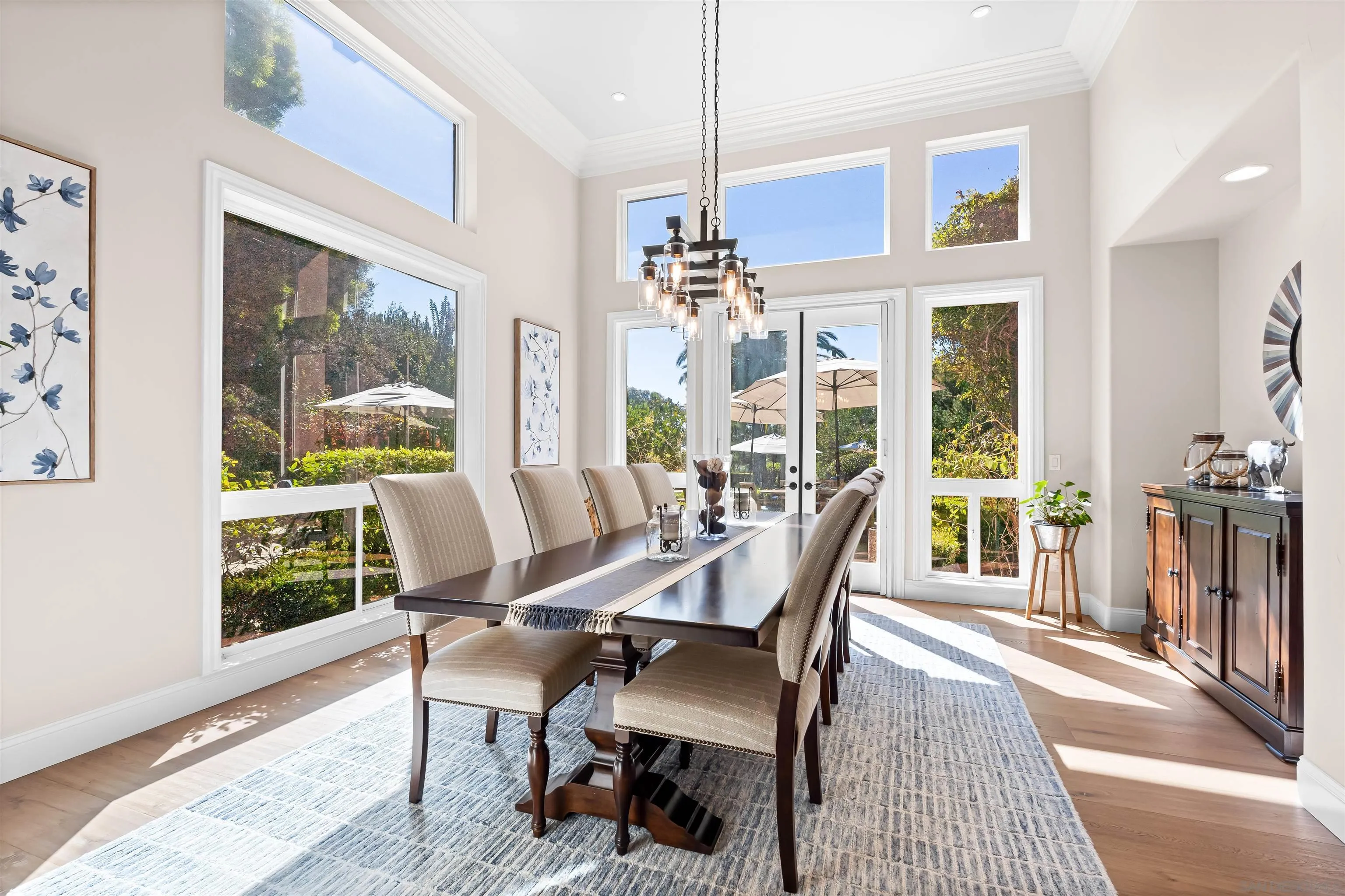 301 Cantle Lane Encinitas, CA 92024 - Photo 19 of 75 a view of a dining room with furniture wooden floor and a chandelier