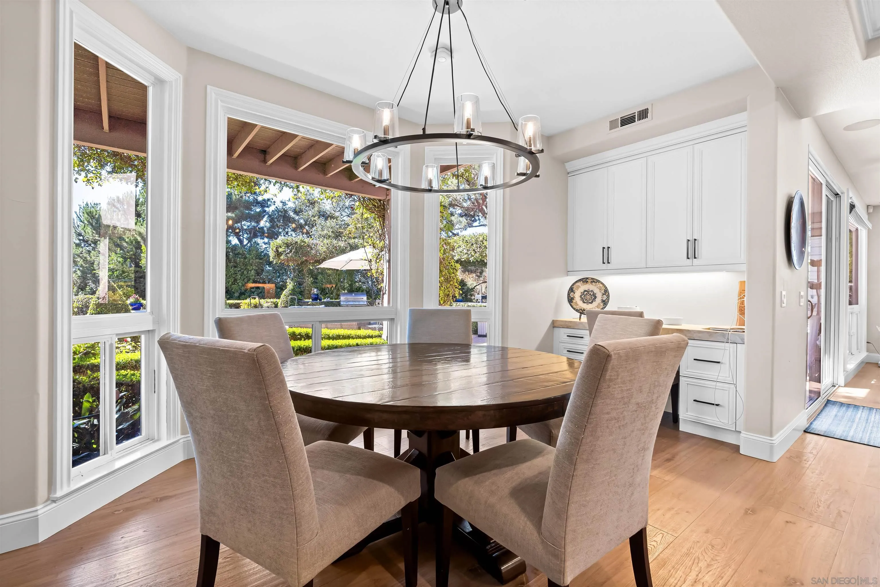 301 Cantle Lane Encinitas, CA 92024 - Photo 20 of 75 a view of a dining room with furniture window and wooden floor