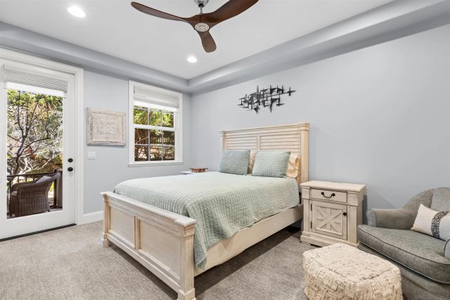 a spacious bedroom with a bed and a flat screen tv