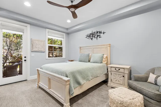 a spacious bedroom with a bed and a flat screen tv