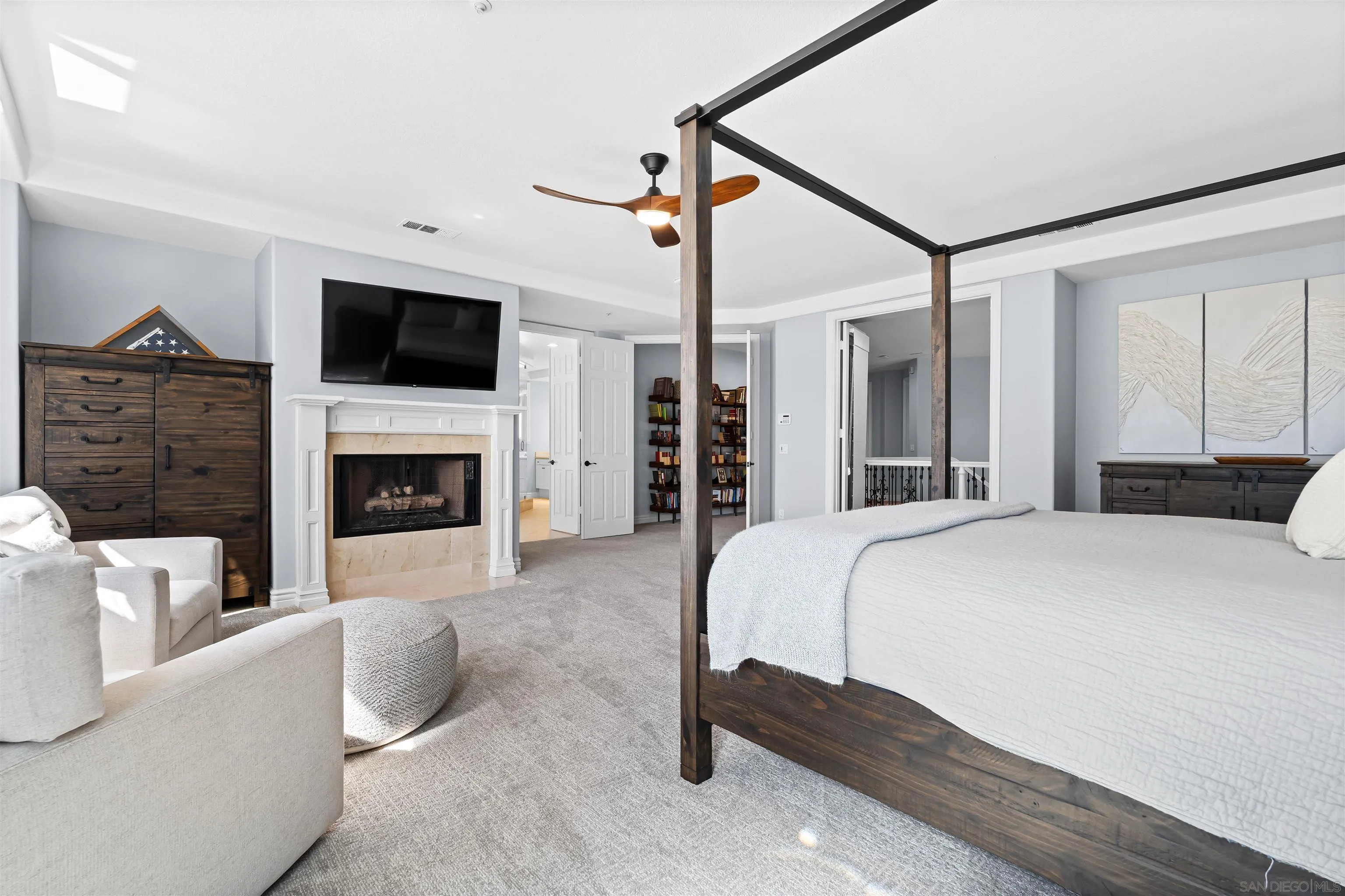 301 Cantle Lane Encinitas, CA 92024 - Photo 35 of 75 a spacious bedroom with a bed and a flat screen tv