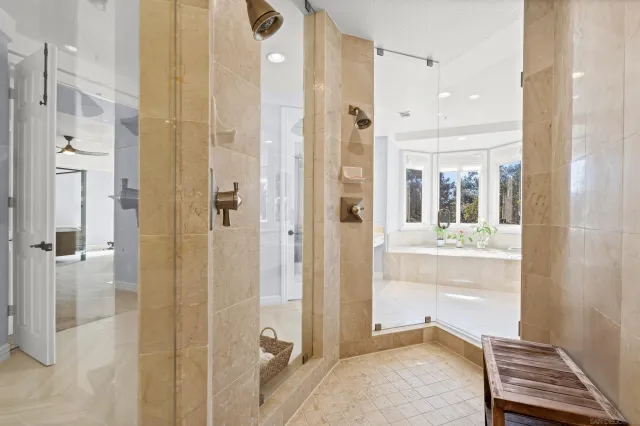 a view of a patio with couches table and chairs under an umbrella with a fire pit