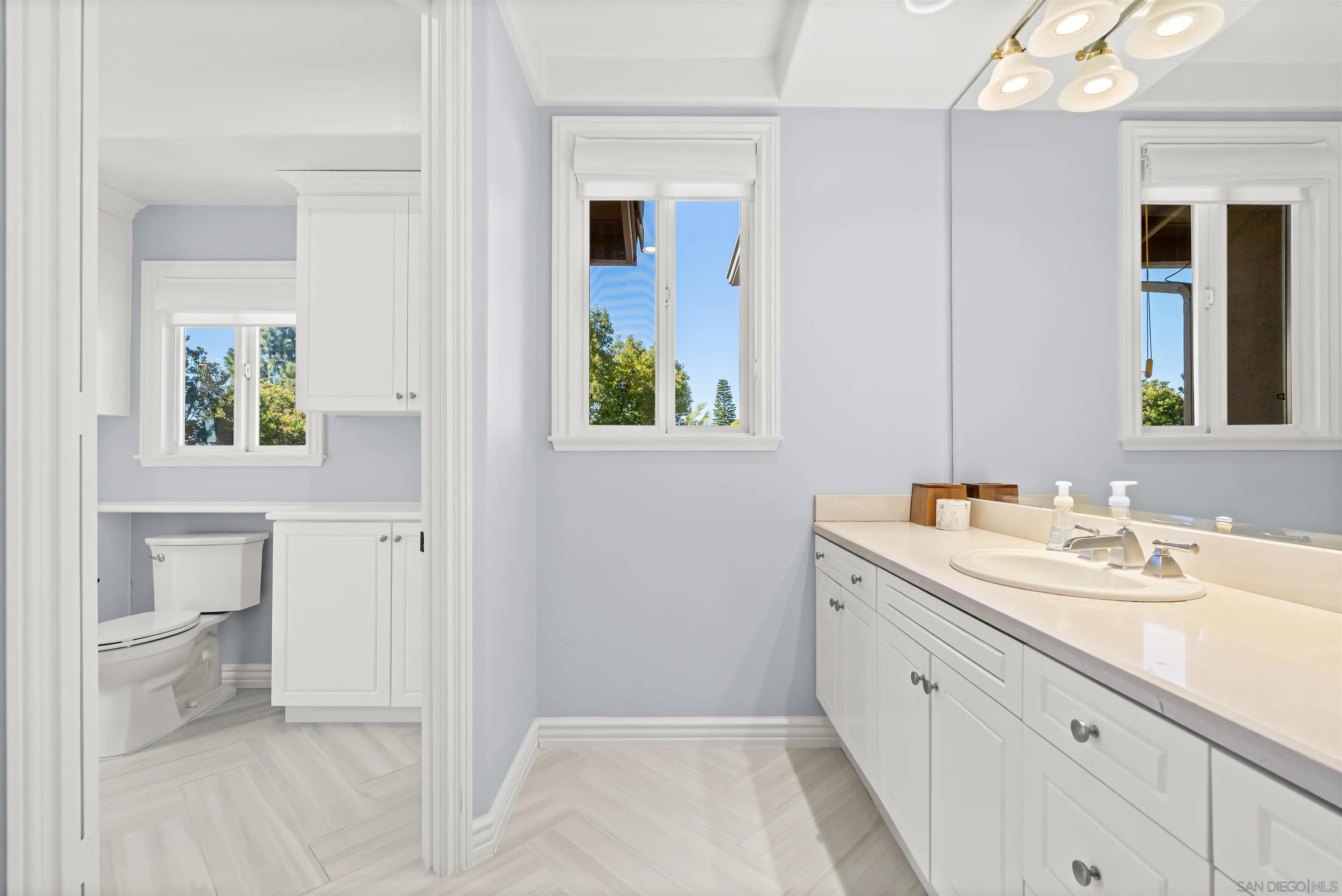 301 Cantle Lane Encinitas, CA 92024 - Photo 39 of 75 a spacious bathroom with a double vanity sink toilet and a mirror