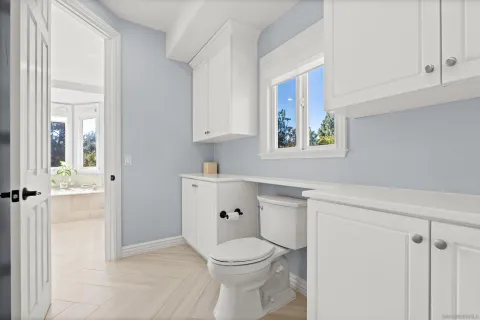 a front view of a house with a tree