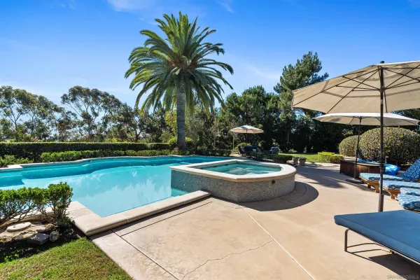 a aerial view of a house with swimming pool and sitting area