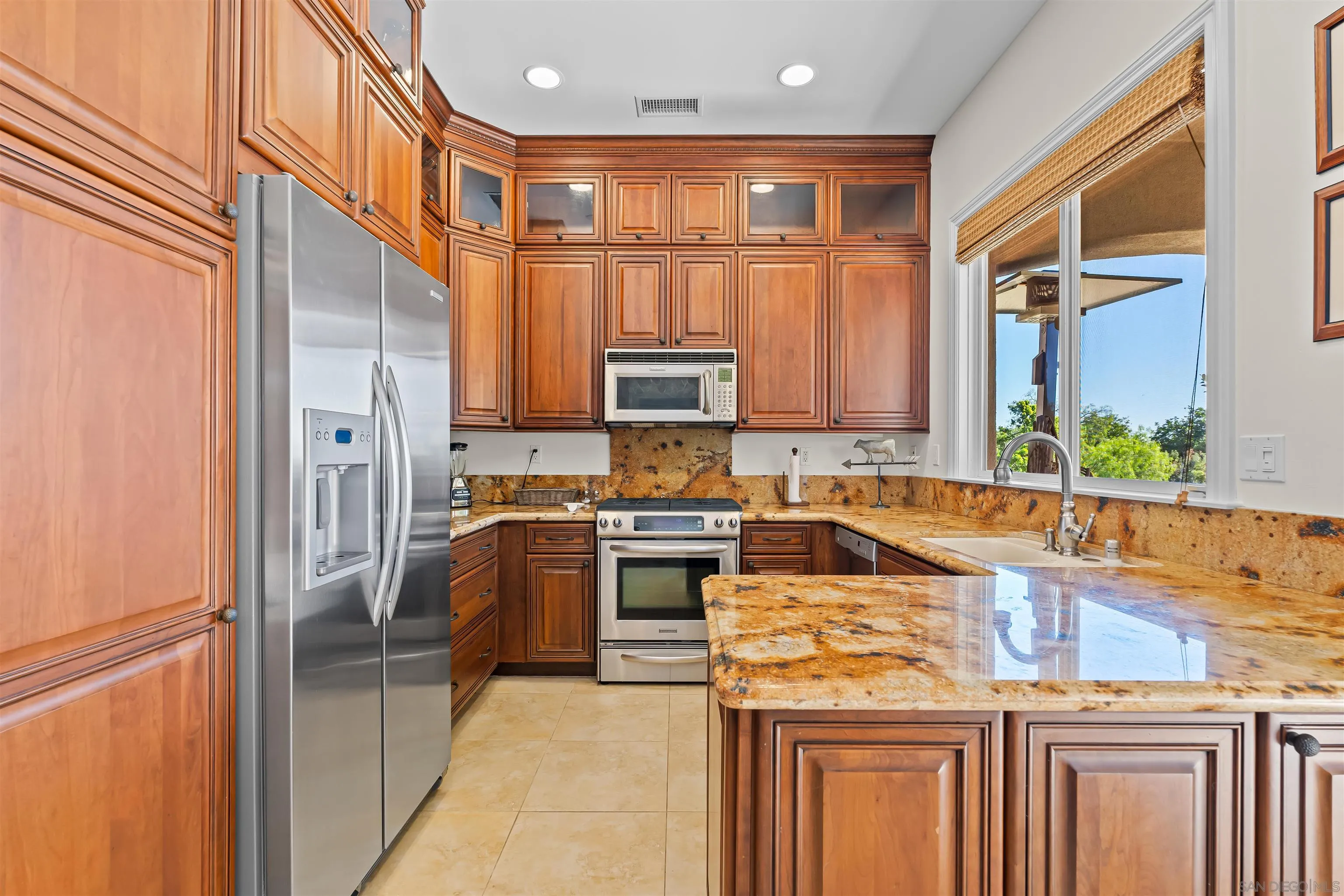 301 Cantle Lane Encinitas, CA 92024 - Photo 59 of 75 a kitchen with stainless steel appliances granite countertop a refrigerator and a stove top oven