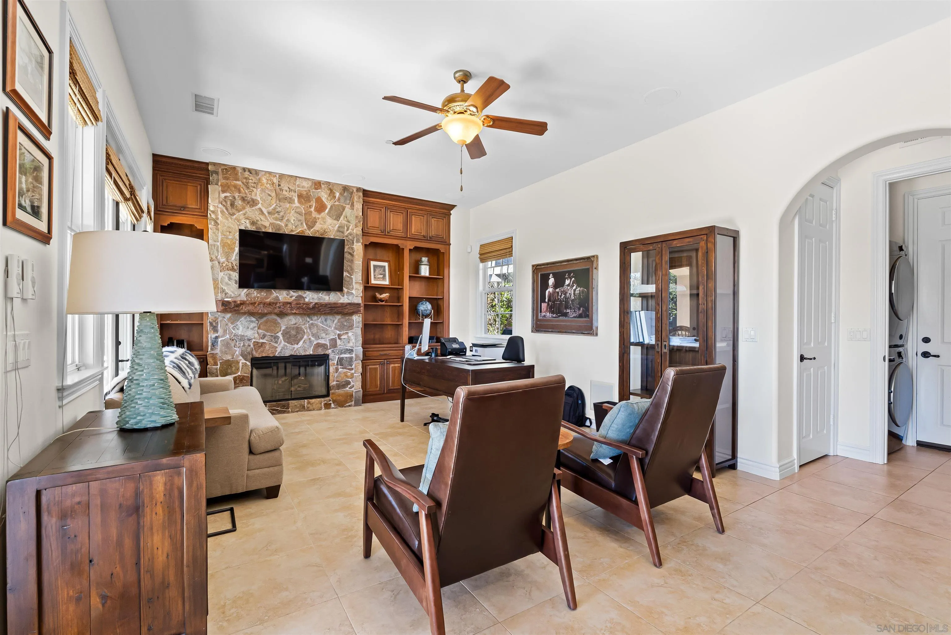 301 Cantle Lane Encinitas, CA 92024 - Photo 62 of 75 a living room with furniture a fireplace and a flat screen tv