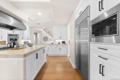 a kitchen with stainless steel appliances kitchen island a sink and a refrigerator