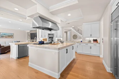 a kitchen with stainless steel appliances granite countertop a stove and a refrigerator