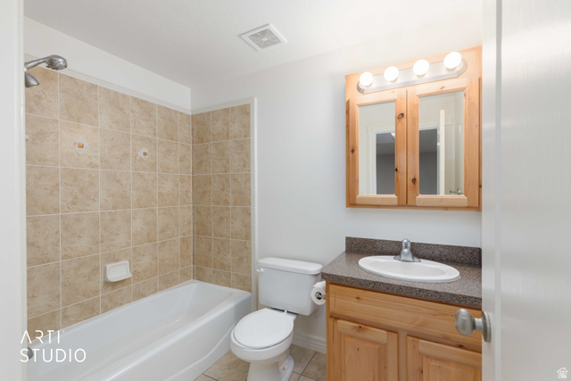 2327 Bluff Ridge Drive Syracuse, UT 84075 - Photo 33 of 66 Bathroom featuring a light wood-finish vanity with a built-in sink, an overhead light fixture, and a mirrored medicine cabinet
