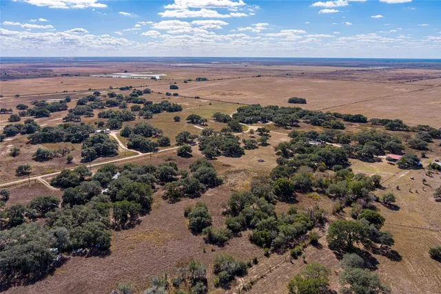 an aerial view of house with yard and ocean view
