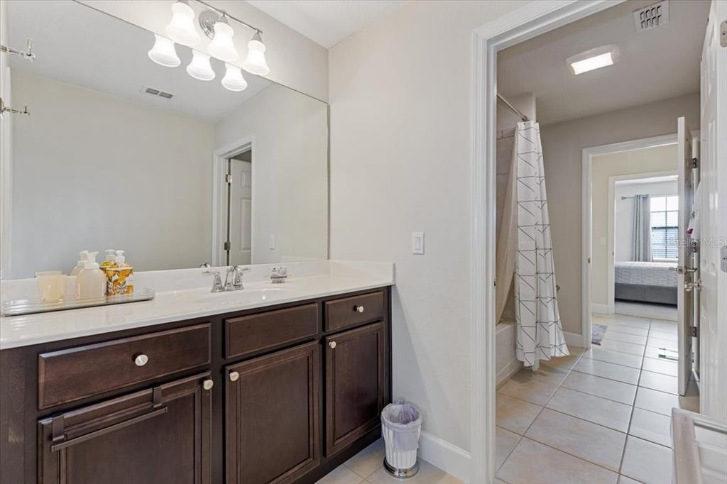 7180 Beek Street Windermere, FL 34786 - Photo 22 of 33 a bathroom with a double vanity sink and a mirror