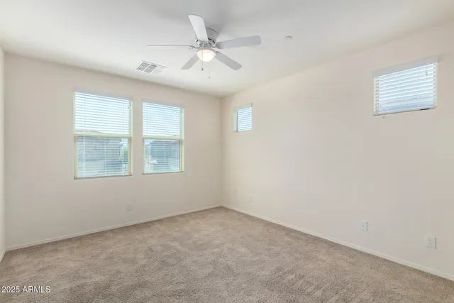 an empty room with fan and a ceiling fan