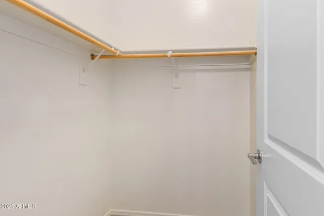 an empty room with closet area