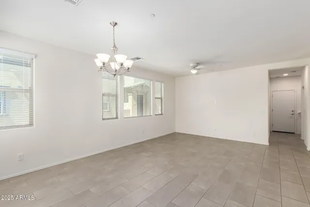 a view of a kitchen with a refrigerator a sink dishwasher a dining table and chairs