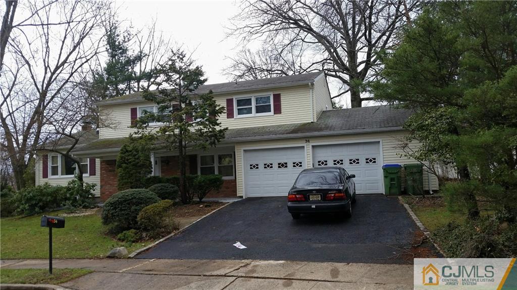 34 Lynnwood Road Edison, NJ 08820 - Photo 1 of 11 a car parked in front of a white house