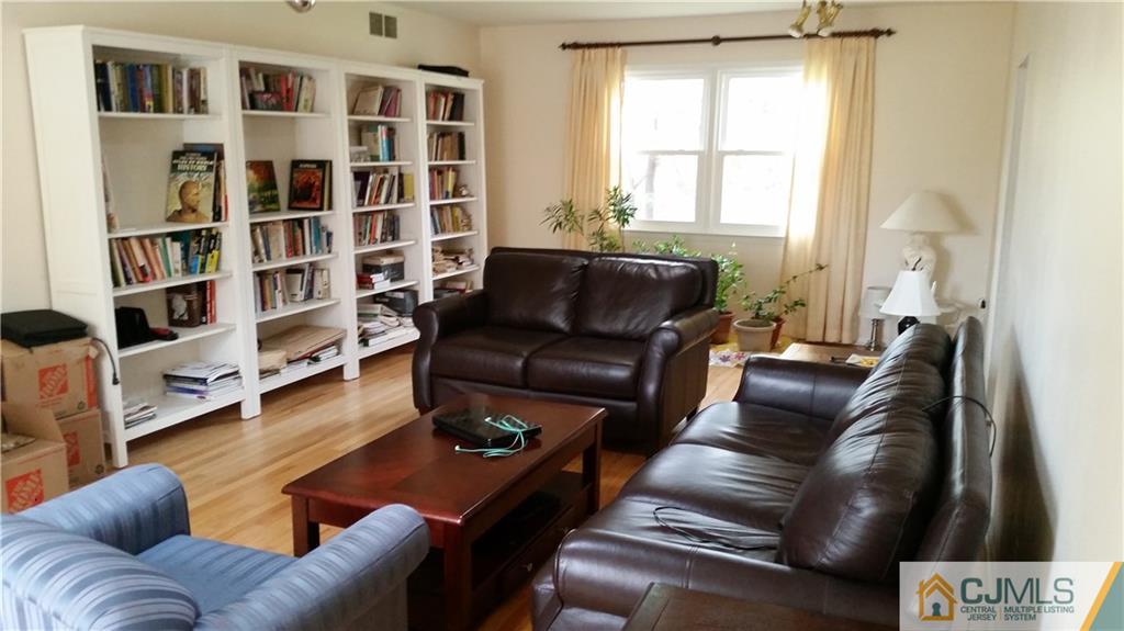 34 Lynnwood Road Edison, NJ 08820 - Photo 5 of 11 a living room with furniture and a book shelf