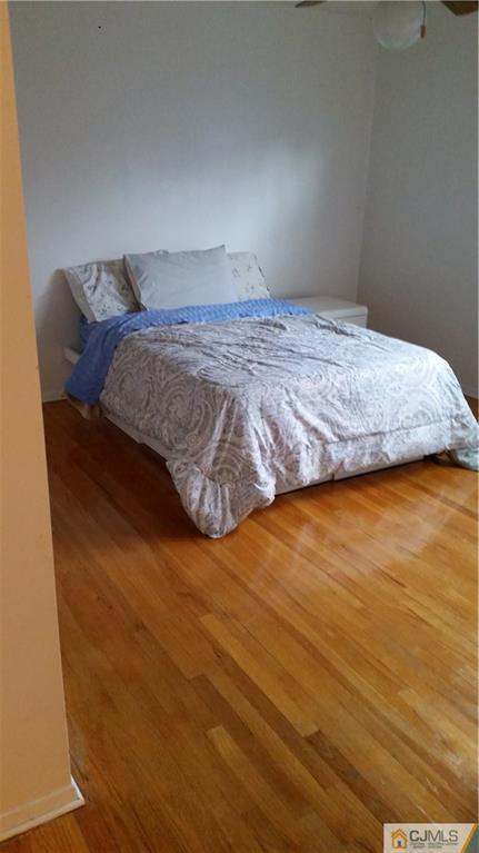 34 Lynnwood Road Edison, NJ 08820 - Photo 8 of 11 a bedroom with a bed and wooden floor