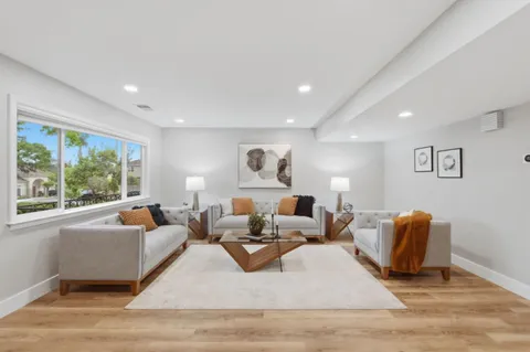 a living room with furniture rug and window