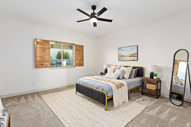912 North Loafer Canyon Road Elk Ridge, UT 84651 - Photo 35 of 98 Recessed lighting, ceiling fan with integrated light, wood-finish window shutters, window with exterior landscaping, and neutral carpeting