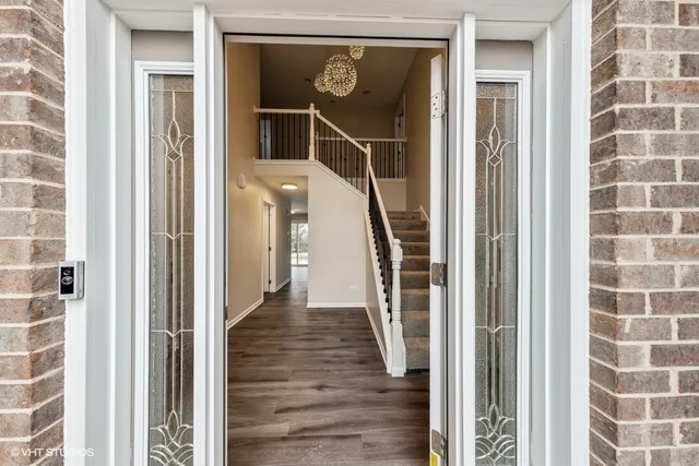 a front door of a house with wooden floor