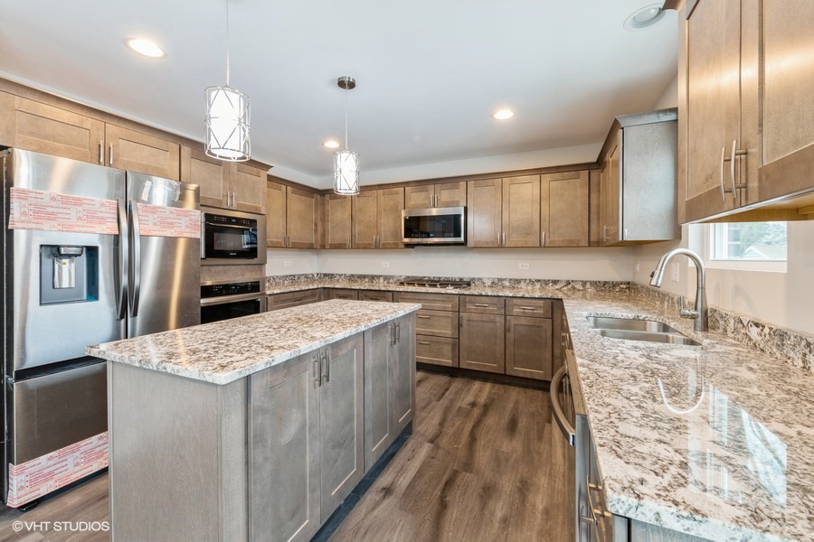 24358 Liberty Street Crete, IL 60417 - Photo 4 of 16 a kitchen with stainless steel appliances granite countertop a sink refrigerator and cabinets