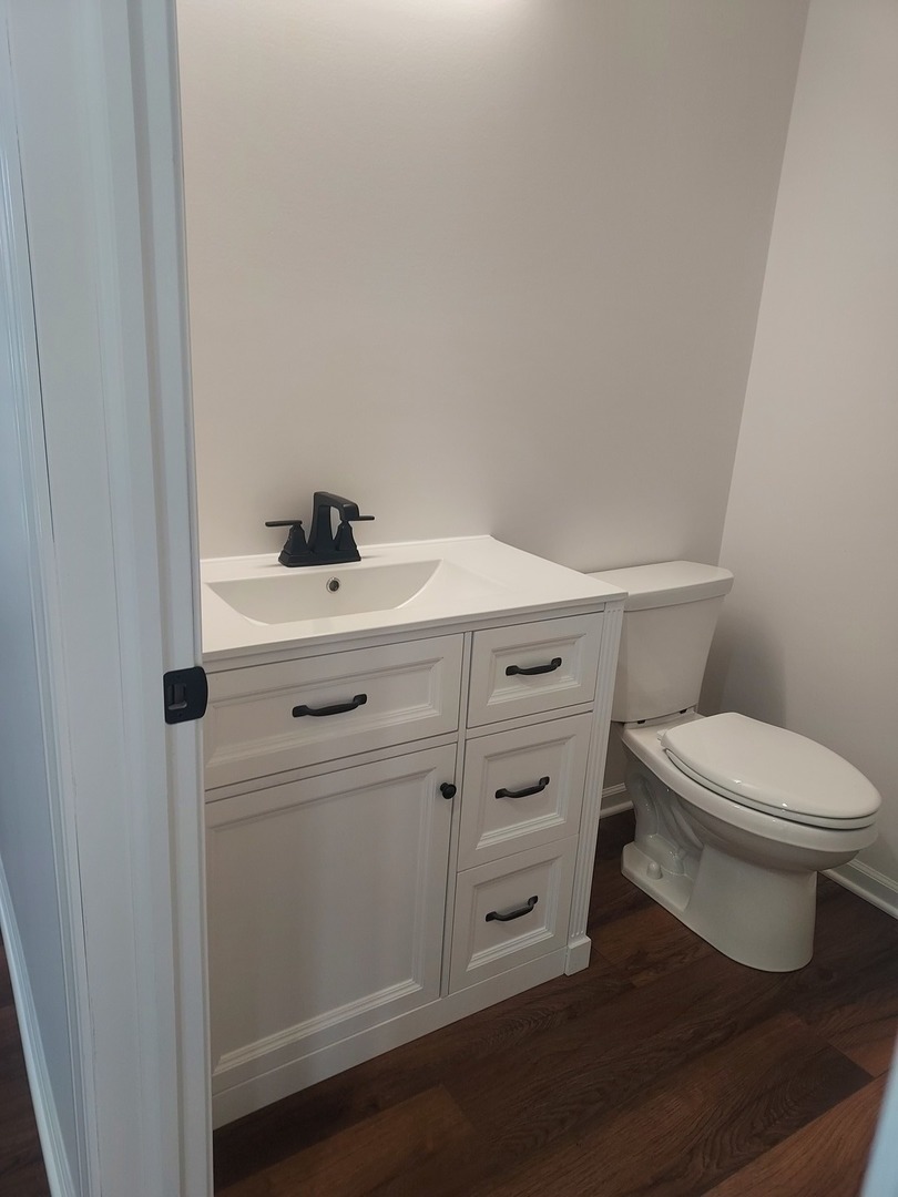 24358 Liberty Street Crete, IL 60417 - Photo 5 of 13 a bathroom with a toilet sink and vanity