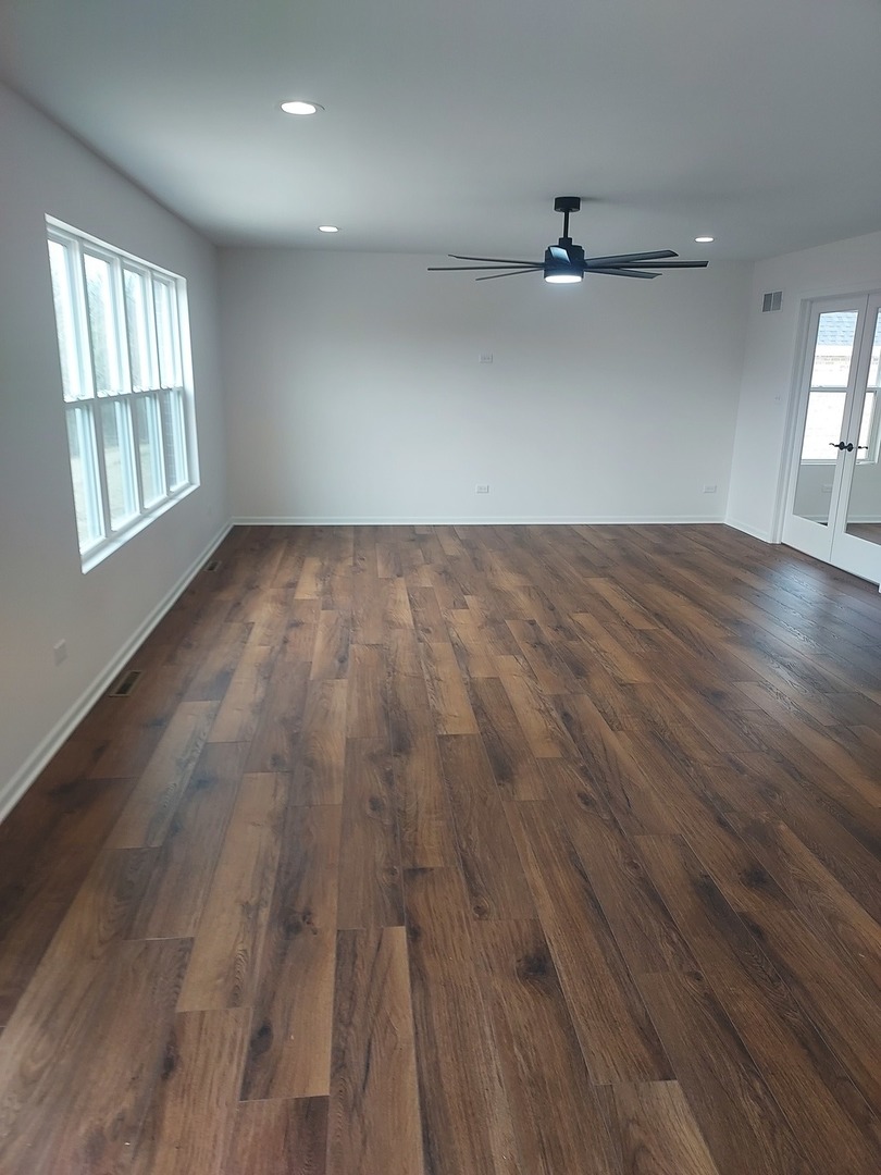 24358 Liberty Street Crete, IL 60417 - Photo 6 of 13 an empty room with wooden floor and windows