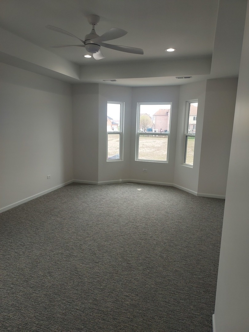 24358 Liberty Street Crete, IL 60417 - Photo 9 of 13 an empty room with a empty space and windows
