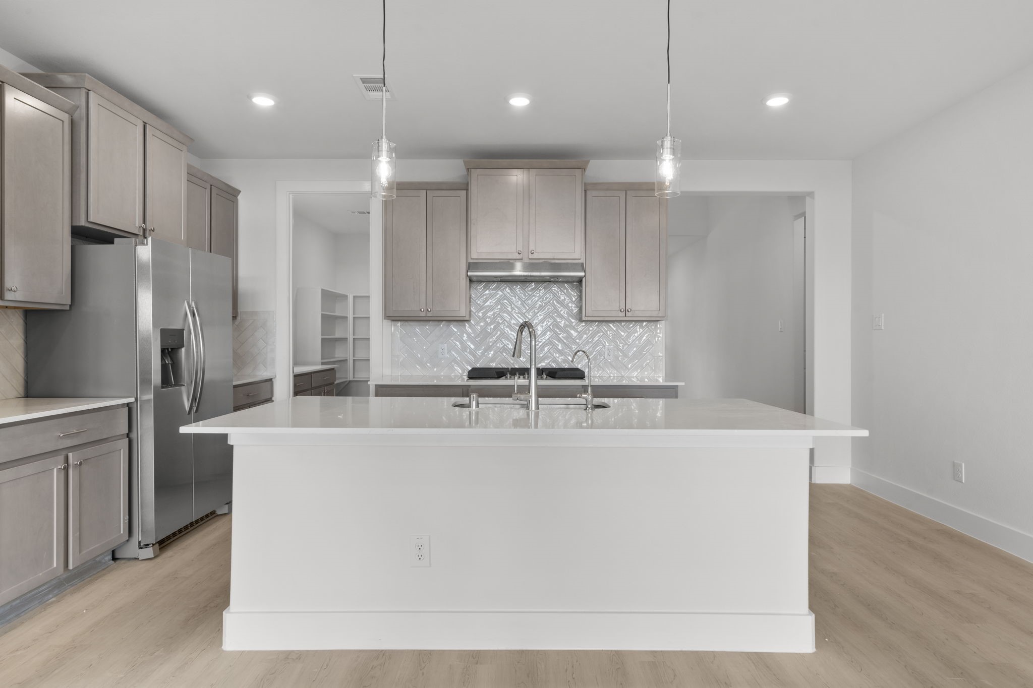 644 Cross Timbers Trace Waller, TX 77484 - Photo 6 of 33 a large kitchen with kitchen island a large counter top stainless steel appliances and cabinets