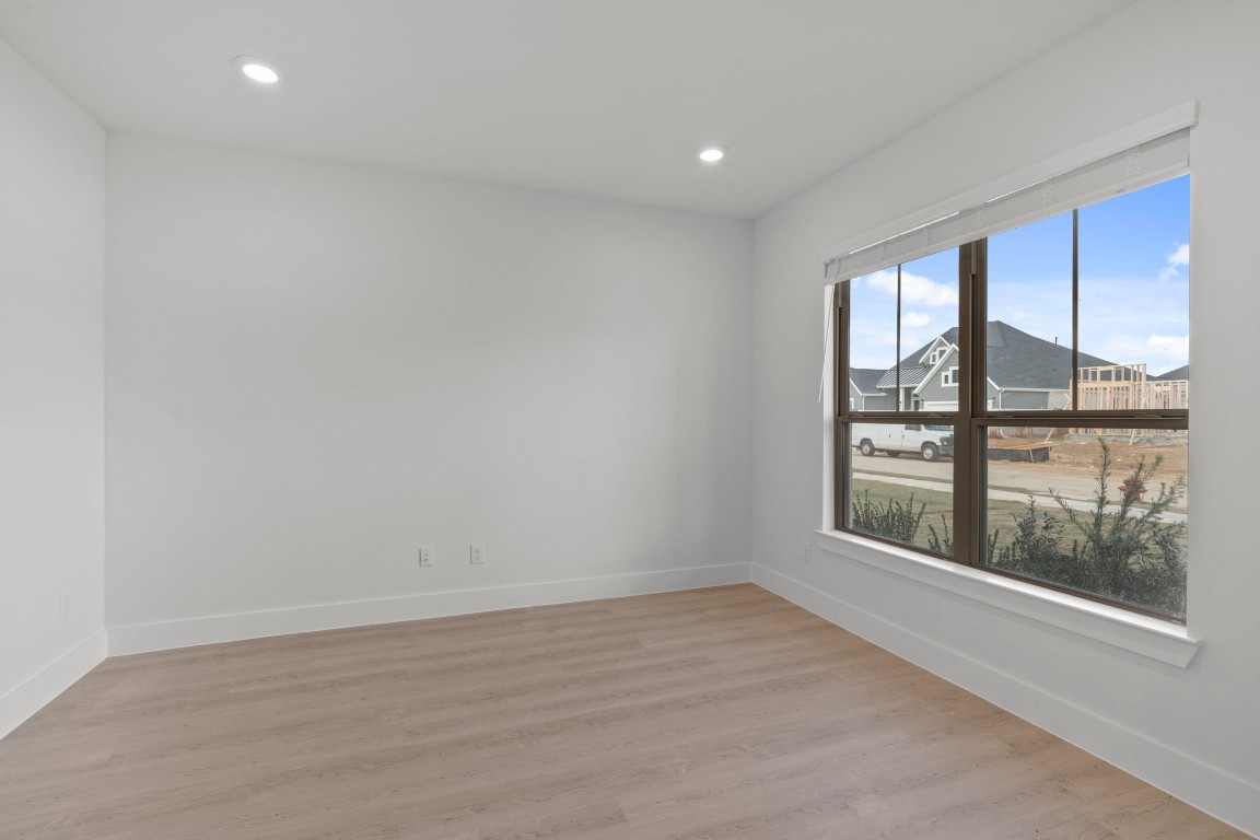 644 Cross Timbers Trace Waller, TX 77484 - Photo 7 of 33 wooden floor in an empty room with a window